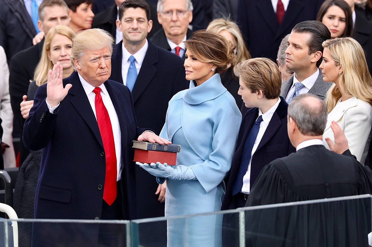 President Donald Trump being sworn in on January 20, 2017 at the U.S. Capitol building in Washington, D.C., holding two Bibles / Wikimedia Commons
