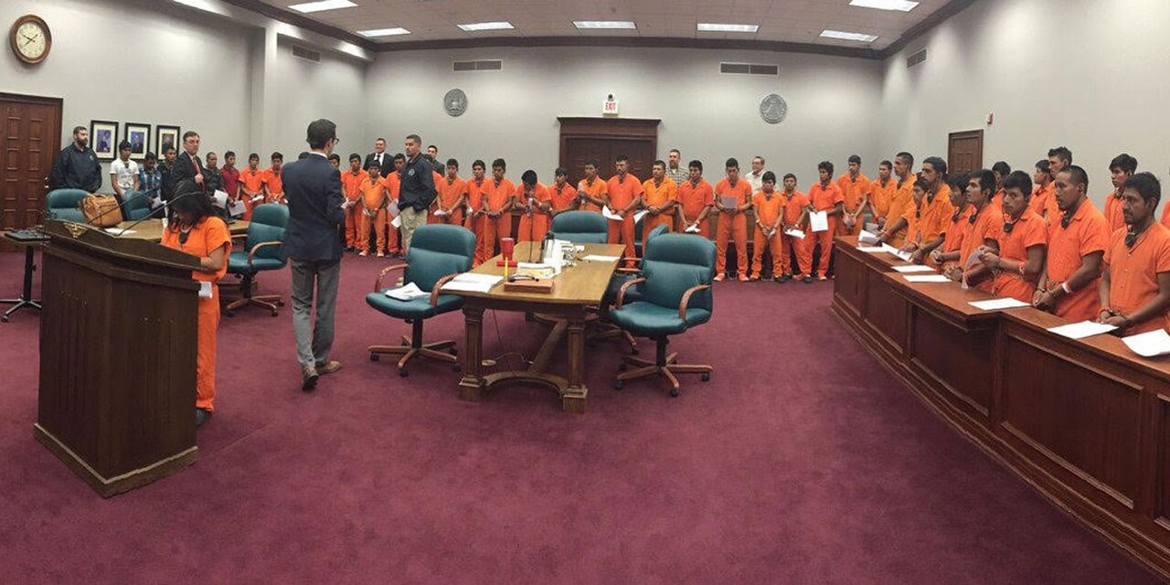 Mass trial of immigrants at the Lucius D. Bunton Federal Courthouse in Pecos, Texas showing defendants in courtroom / U.S. Department of Justice