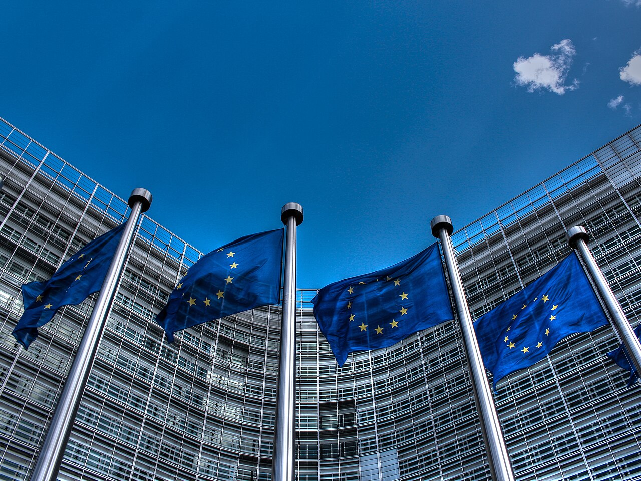European Union flags displayed in front of the Berlaymont Building, the European Commission headquarters in Brussels / Photo by European Union