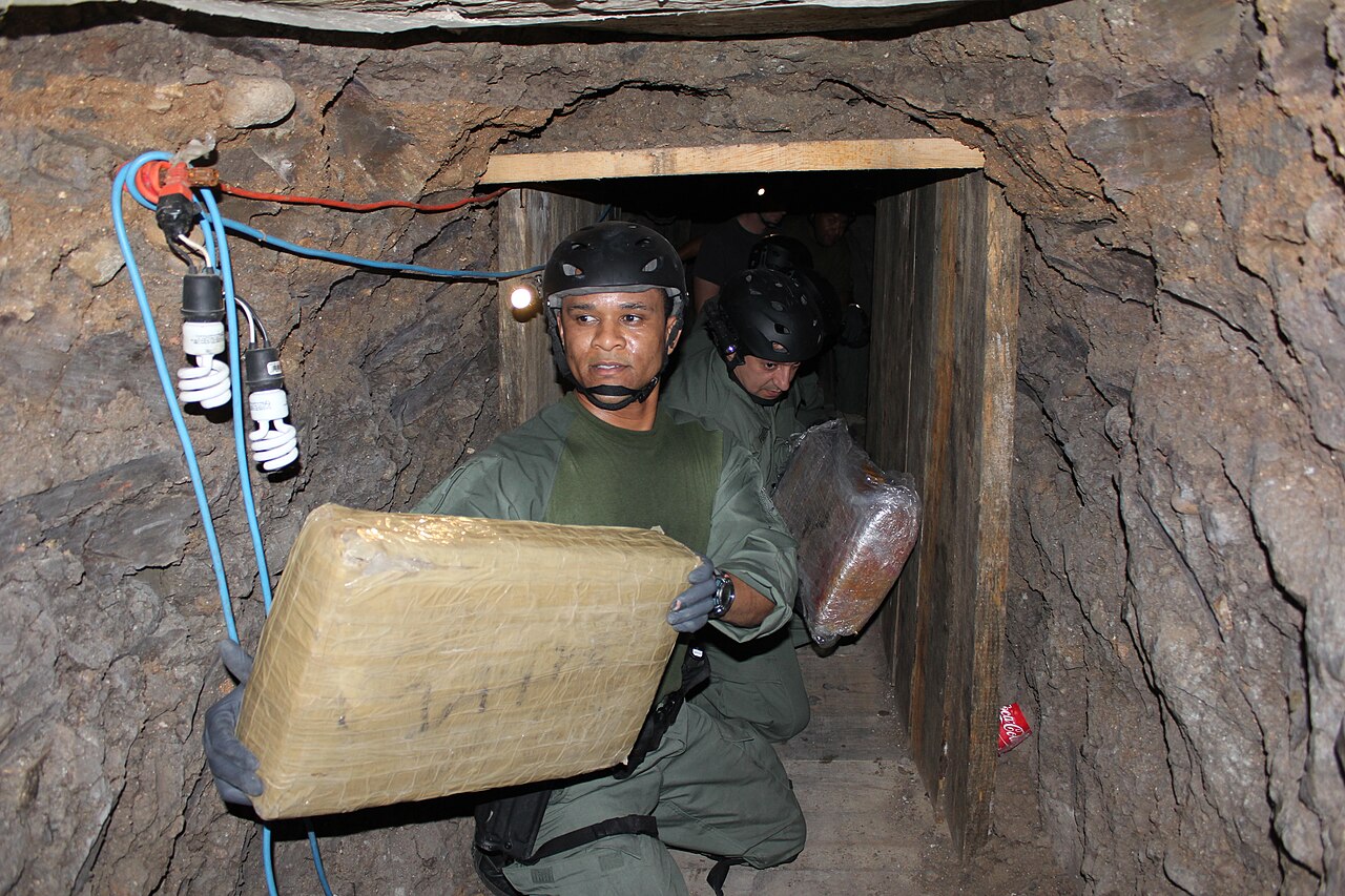 Elaborate cross-border drug smuggling tunnel discovered inside a warehouse near San Diego, showing exposed earth walls and underground passage / U.S. Immigration and Customs Enforcement/Ron Rogers
