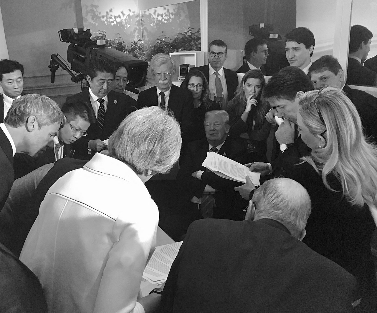 Donald Trump meeting with world leaders at the 2018 G7 summit for negotiations on trade, Iran, and national security / @POTUS via Wikimedia Commons, public domain