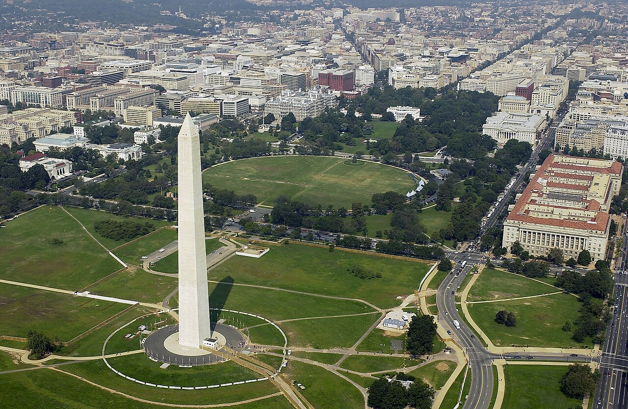 Aerial view of the Washington Monument with the White House visible in the background, showing the National Mall in Washington, D.C. / Public domain
