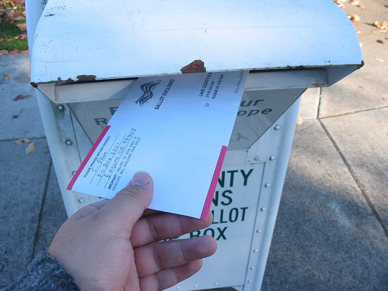 A voter returns a vote-by-mail ballot in a secure drop box during the 2006 General elections in Lane County, Oregon / Photo by Oregon Secretary of State